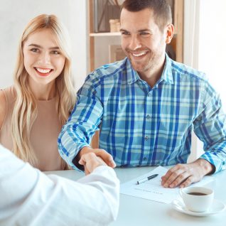 Young couple rent apartment together in the office signing contract